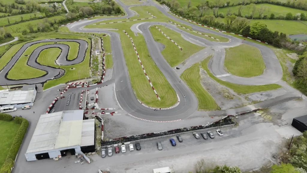 Aerial view of outdoor karting event circuit with natural landscape surroundings Outdoor Karting Circuit Overview
